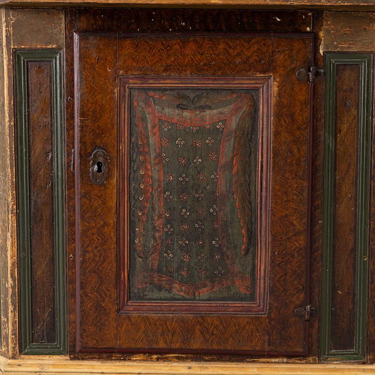 A corner cupboard, dated 1779.