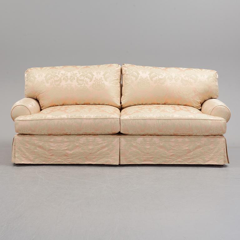 A sofa upholstered with silk damask.