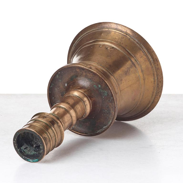 A CANDLESTICK, bronze/copper alloy, Ottoman, Turkey 16th-17th century, height 24 cm, the foot diameter 15,5 cm.