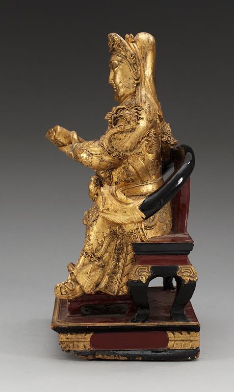 A wooden gilt lacquer figure of a warrior diety, Qing dynasty, 18/19th Century.