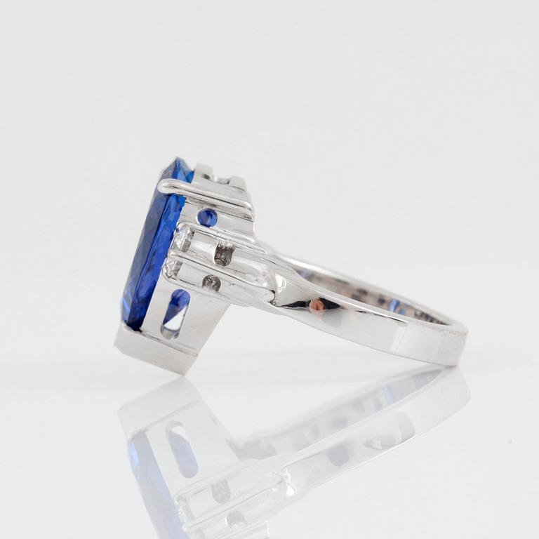 A pear-shaped tanzanite and brilliant-cut diamond ring. Total carat weight of diamonds 0.40 ct.