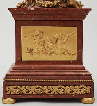 A Louis XVI-style late 19th century gilt bronze and marble vase clock "Pendule à cercles tournants", Dufaud Paris.