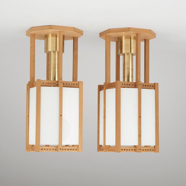 A pair of John Kandell oak, brass and opaque glass celing lamps, Sweden 1950's.