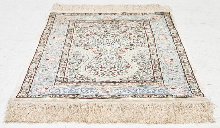 A silk Hereke rug, Turkey, approx. 82 x 58 cm.