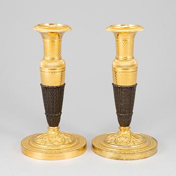 A pair of empire, ormolu candlesticks, first half of the 19th century.