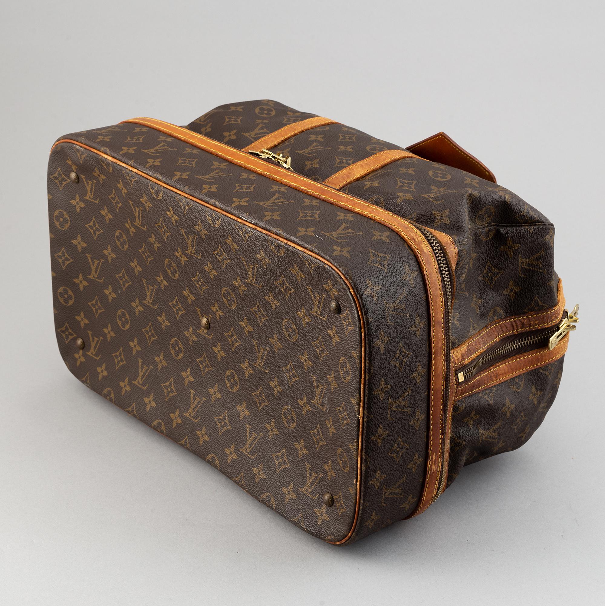 Louis Vuitton, a monogram canvas weekend bag.