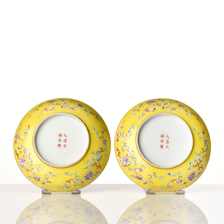 A pair of yellow ground famille rose dishes, Qing dynasty, with Guangxu mark and period, circa 1900.