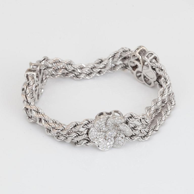 A brilliant-cut diamond flower bracelet.