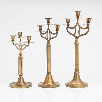 Three brass candlesticks from the early 20th Century.