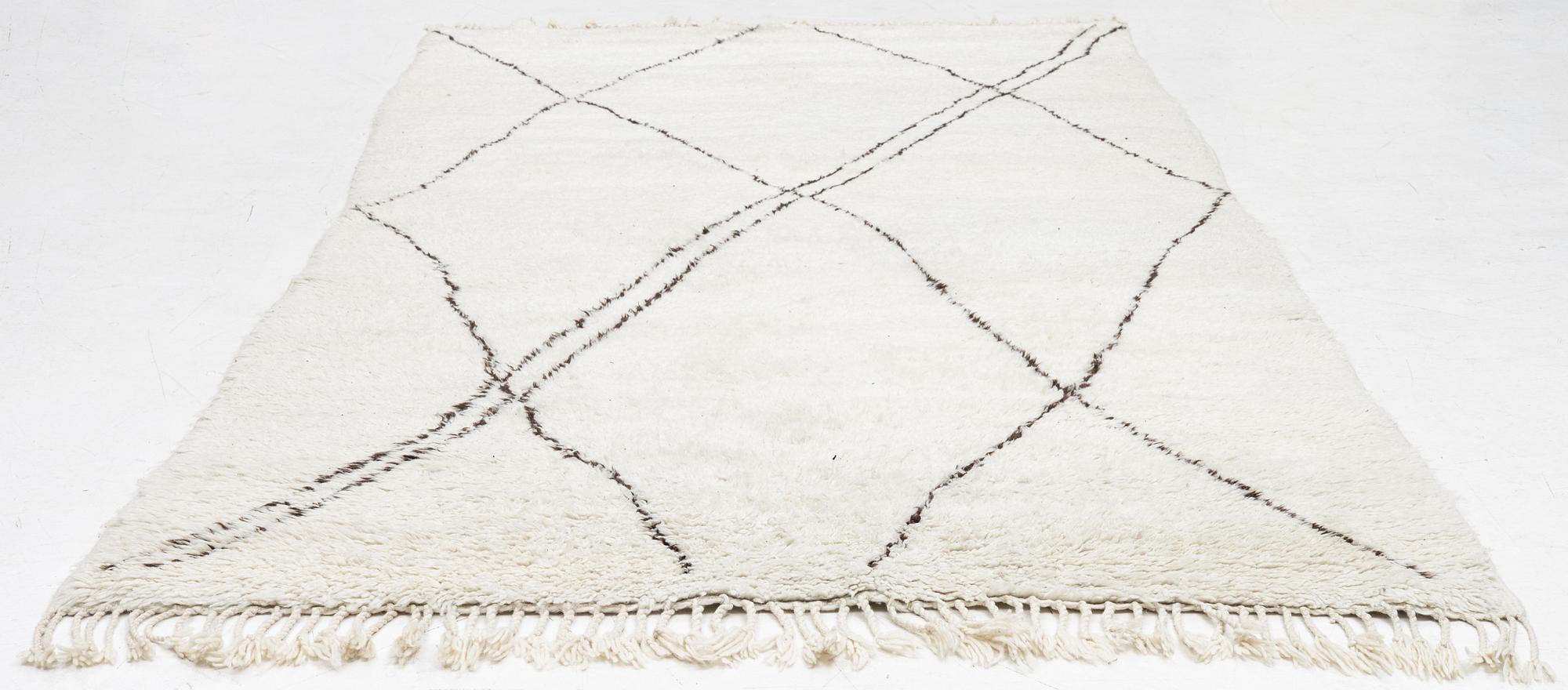 A Moroccan carpet, c. 282 x 150 cm.