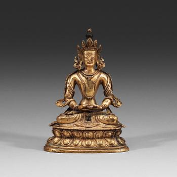 A seated Sino-Tibetan gilt bronze figure of Amitauys, 18th Century.