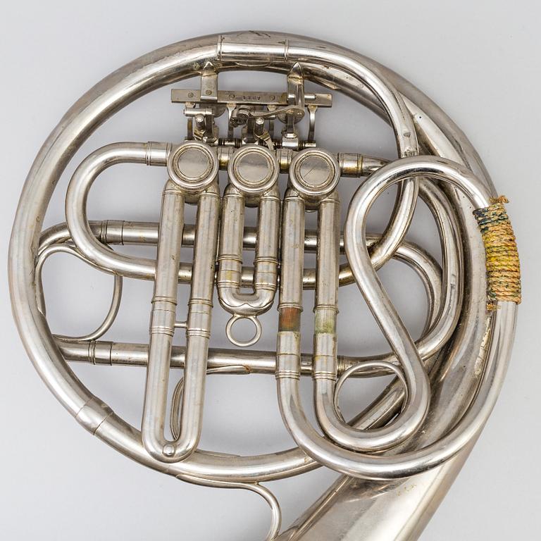 A metal french horn, probably 1936.