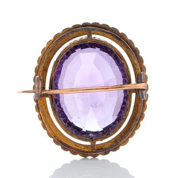 An amethyst brooch set with pearls.