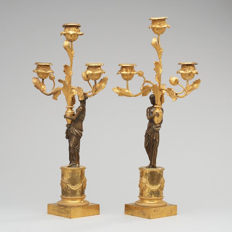 A pair of Louis XVI circa 1800 three-light candelabra.
