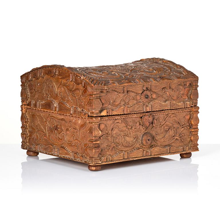 A baroque wedding casket, carved wood, dated 1725.