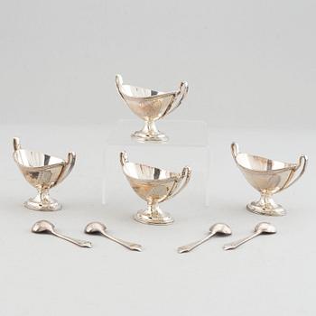 Four silver salt cellars with spoons, Edward Barnard & Sons Ltd, London, England, 1880.