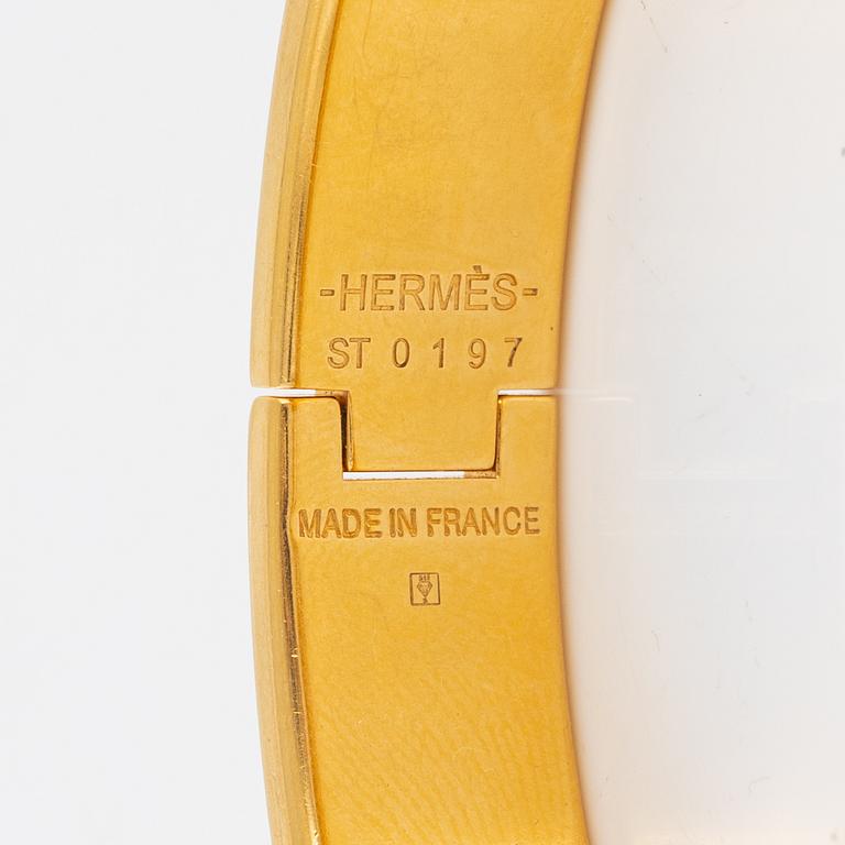 Hermès, a 'Clic H PM' bracelet.