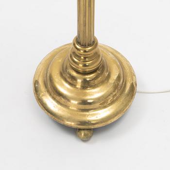 A brass floor lamp.