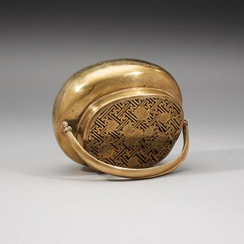 A Chinese engraved paktong hand warmer, Qing dynasty, 19th Century.