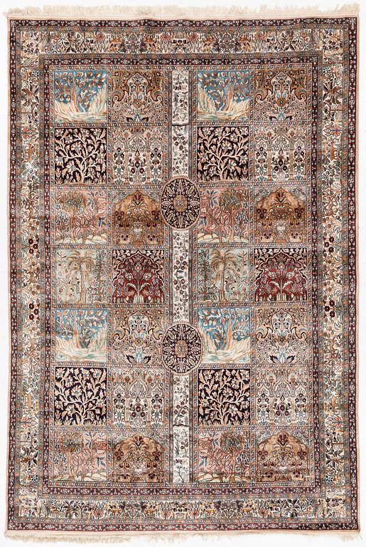 An oriental silk carpet, c. 305 x 205 cm.
