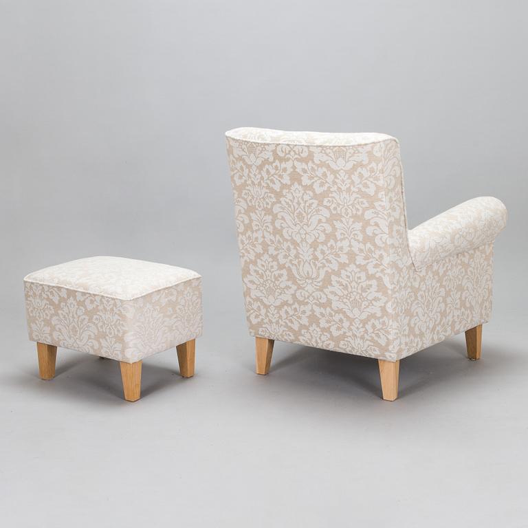 A mid-20th-century armchair and ottoman.