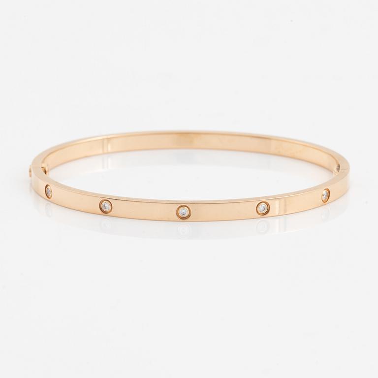 A Cartier "Love" bracelet small model in 18K rose gold with ten round brilliant-cut diamonds.