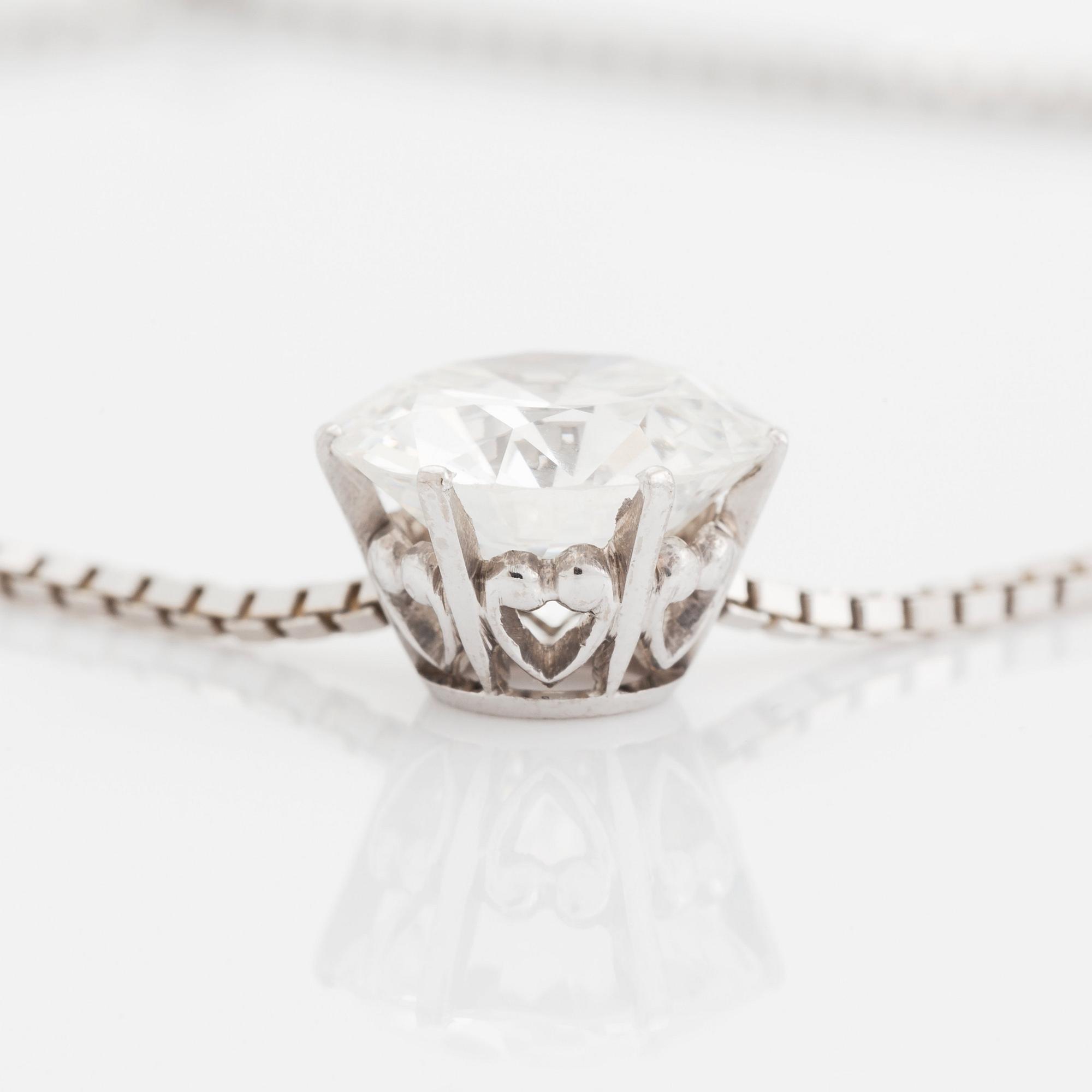 An 18K white gold pendant set with a round brilliant-cut diamond weight ca 3.50 cts quality ca H si.