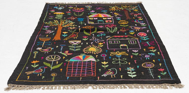 A hand-embroidered Kilim rug, c. 184 x 115 cm.