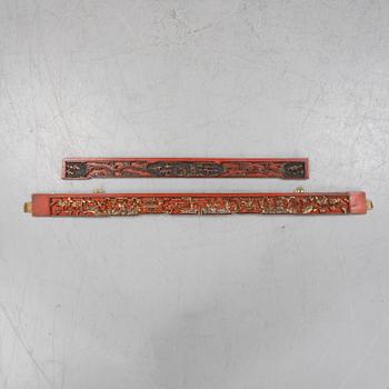 Two Chinese red lacquered wooden panels, 20th century.