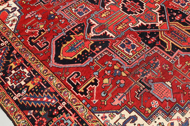 A semi-antique Heris carpet, approx. 343 x 260 cm.