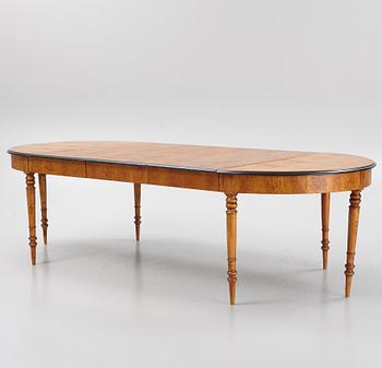 A birch veneered dining table, second half of the 19th Century.