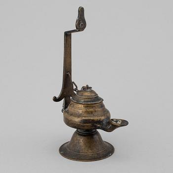 An 18th century bronze oil lamp.