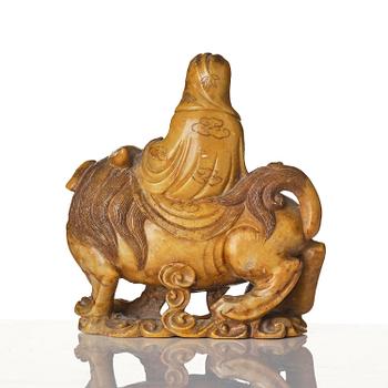 A well carved soapstone sculpture of Guanyin seated on Xiezhai, Qing dynasty, 18th/19th century.