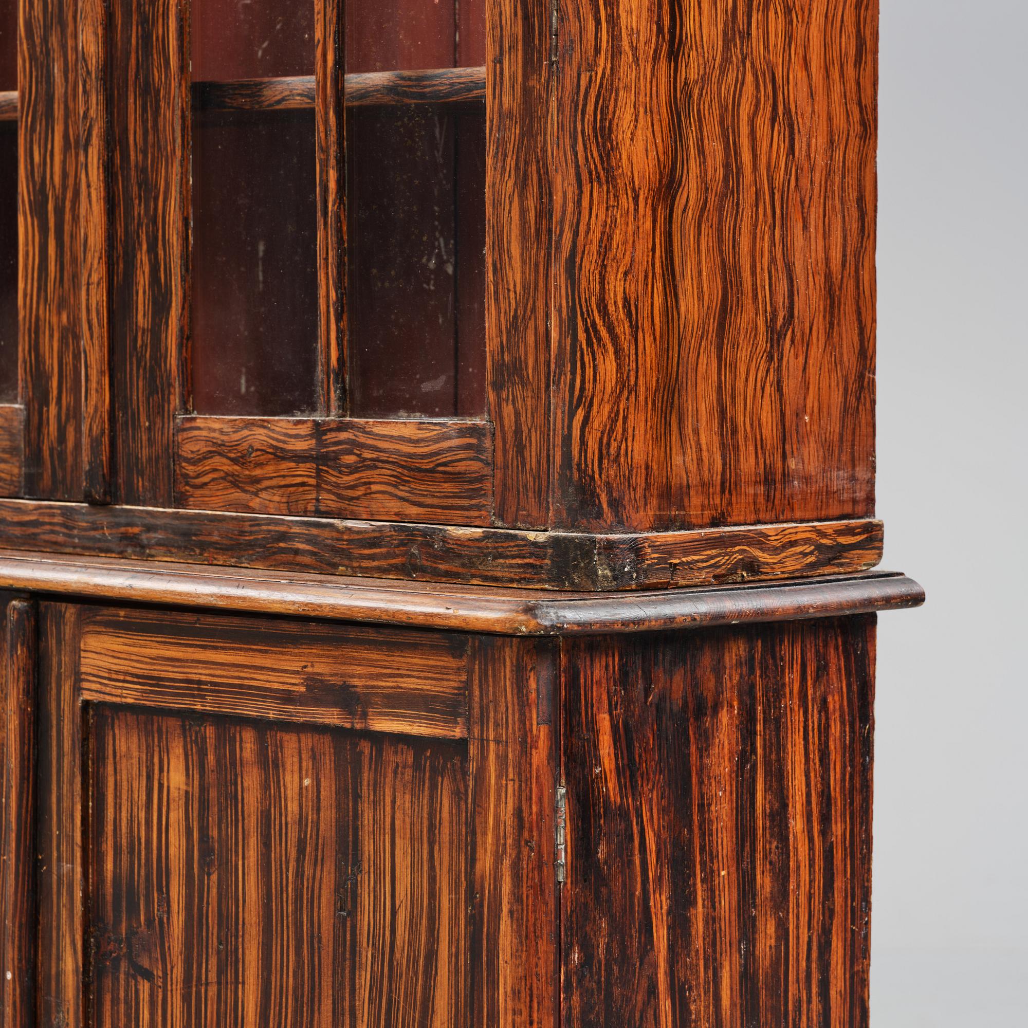 A Swedish faux-boix neo-gothic book cabinet, ca 1830.