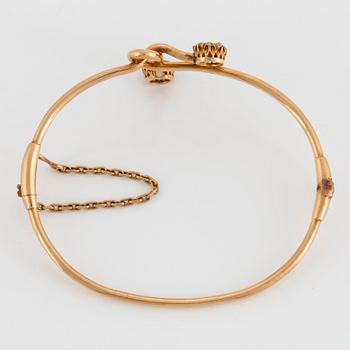 A 14K gold bangle set with old- and rose-cut diamonds.