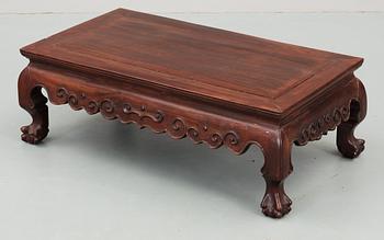 A hardwood 'claw on ball' low table, Qing dynasty.