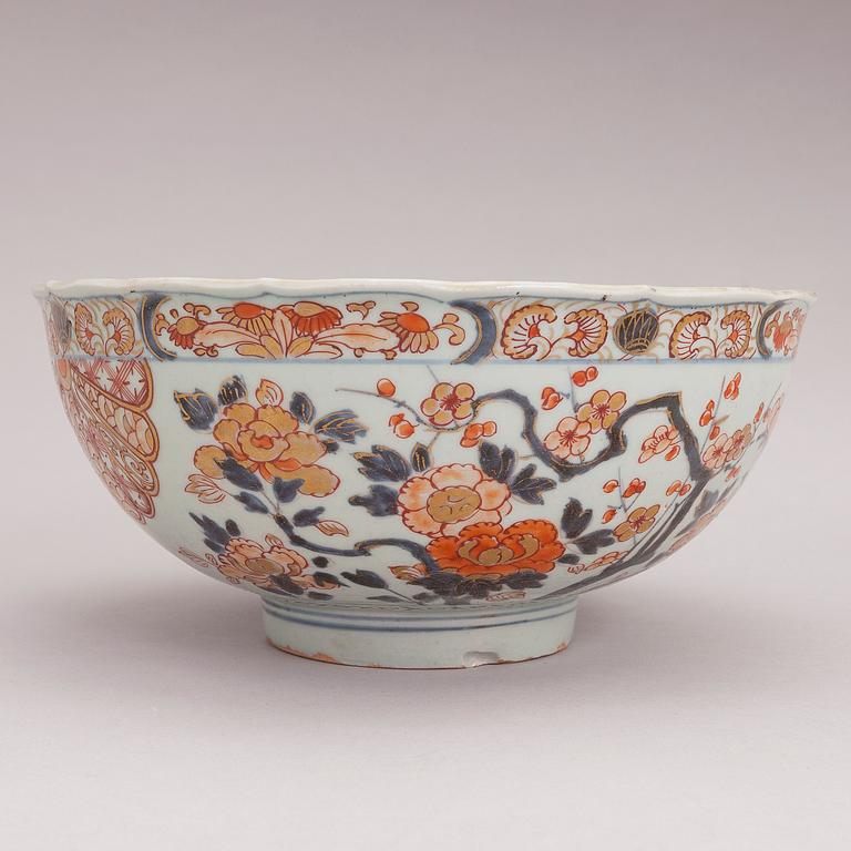 Four Chinese porcelain dishes and a Japanese porcelain bowl, 18th Century.