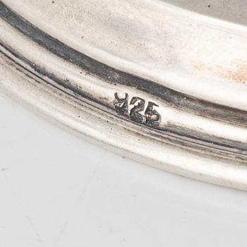 A pair of silver candle holders, marked 825.