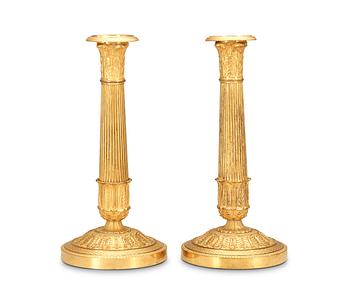 521. A pair of French Empire early 19th Century candlesticks.