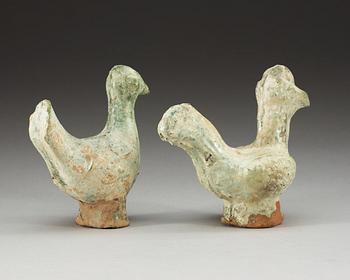 A set of two green glazed pottery models of a rooster and a hen, Han dynasty (206 BC- 220 AD).