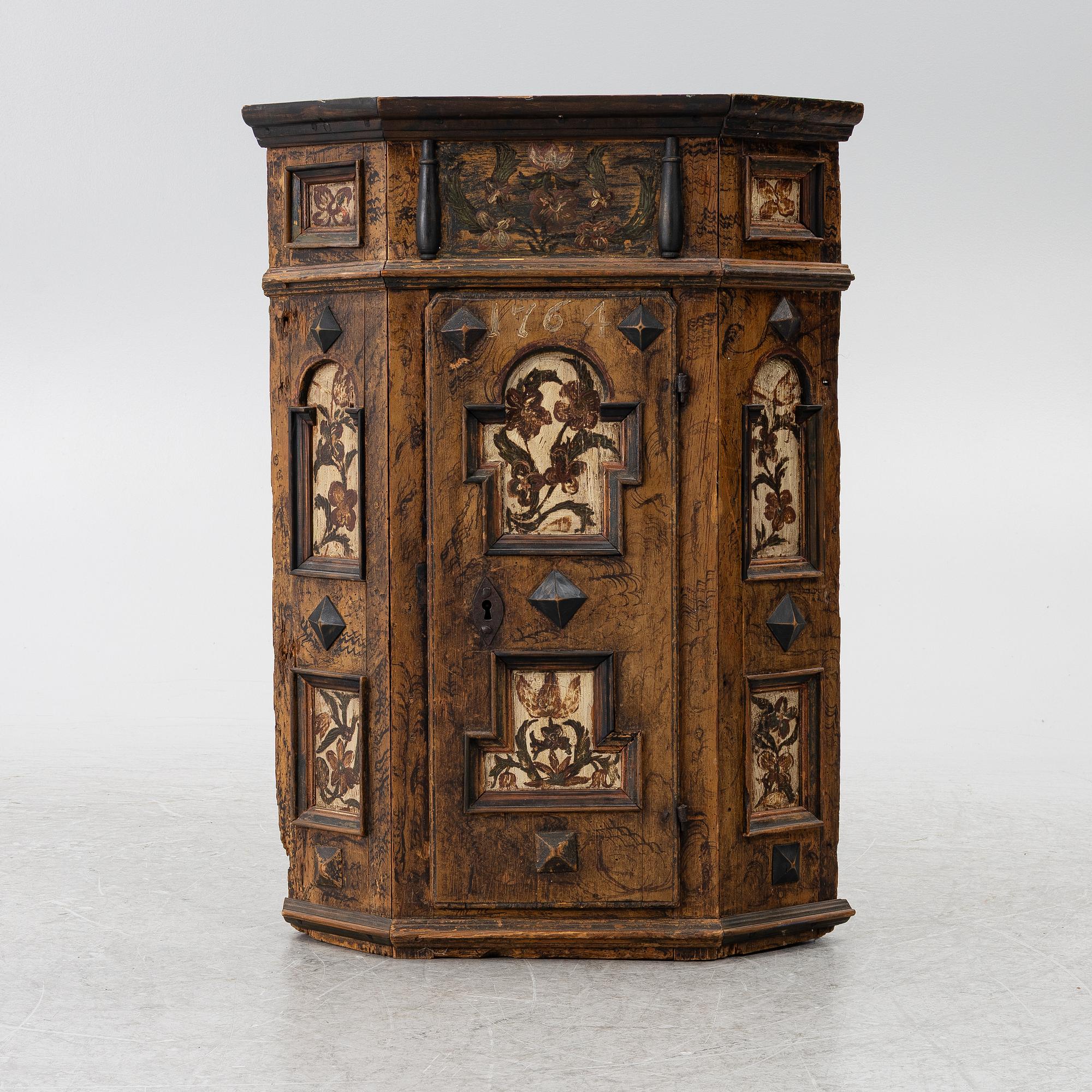 A corner cabinet, 18th Century.