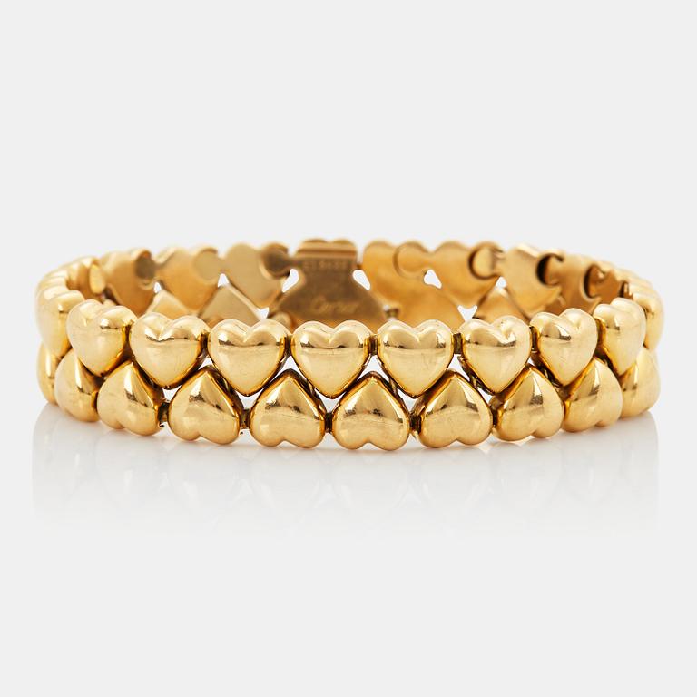 A Cartier 18K gold "Double Hearts" bracelet.