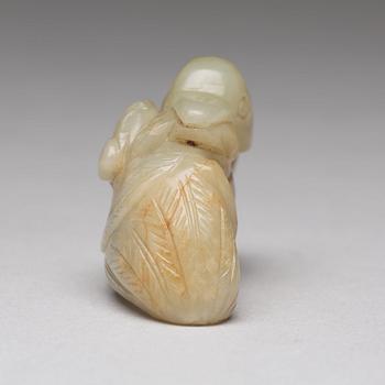 A Chinese nephrite figure of a duck with a lotus bud.