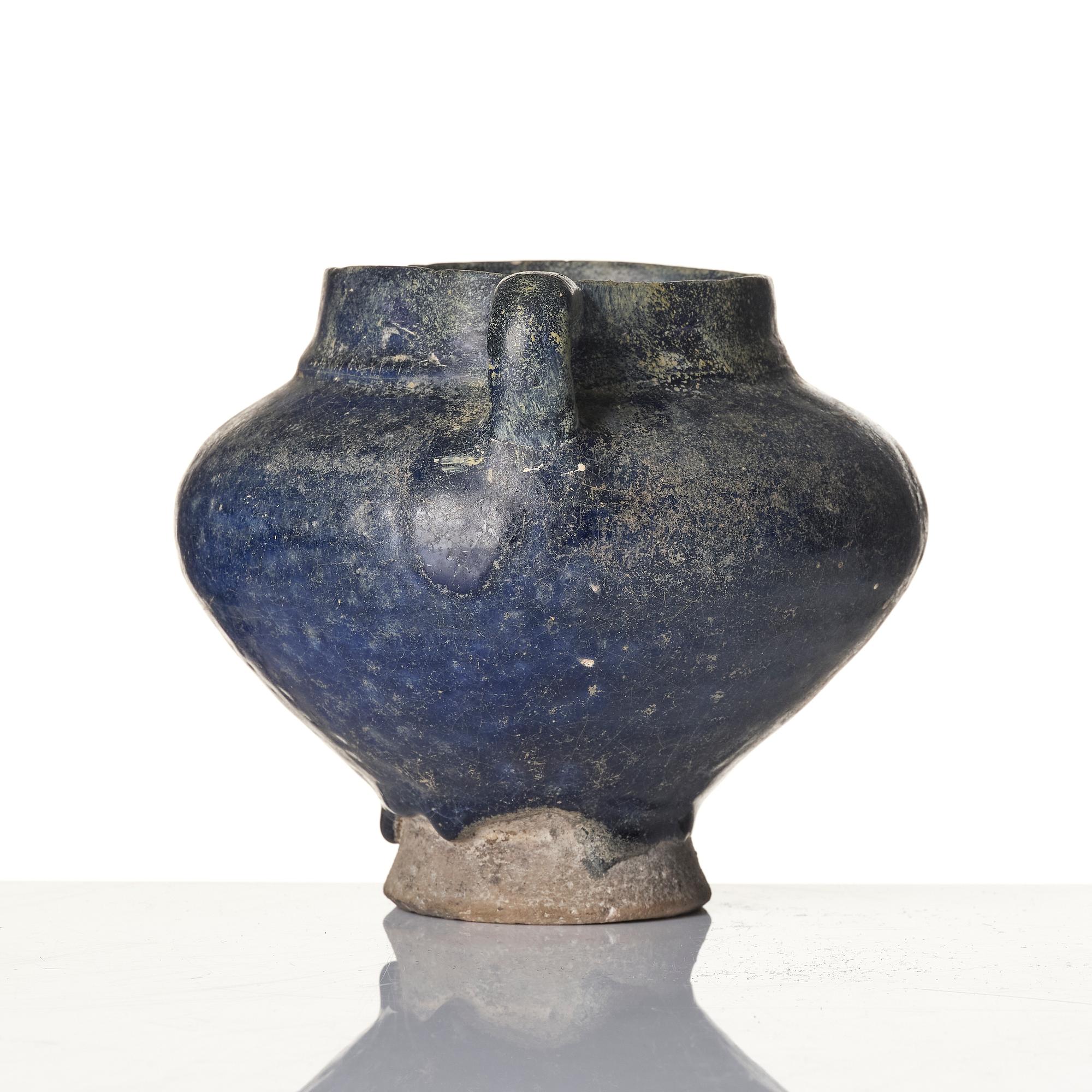 A blue-glazed Nishapur pottery Jug, Persia, 13th century.
