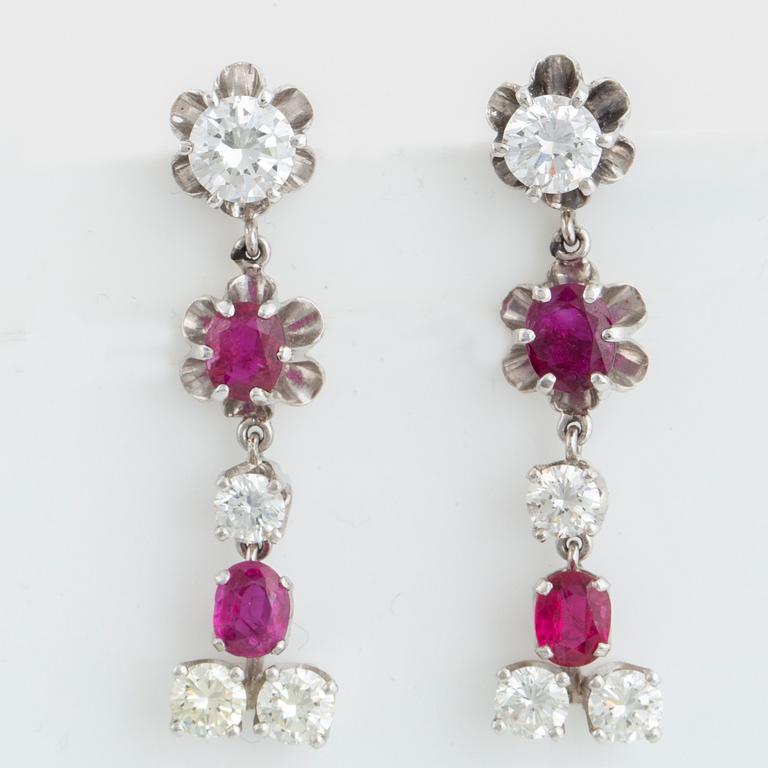 Oval faceted ruby and brilliant-cut diamond earrings.