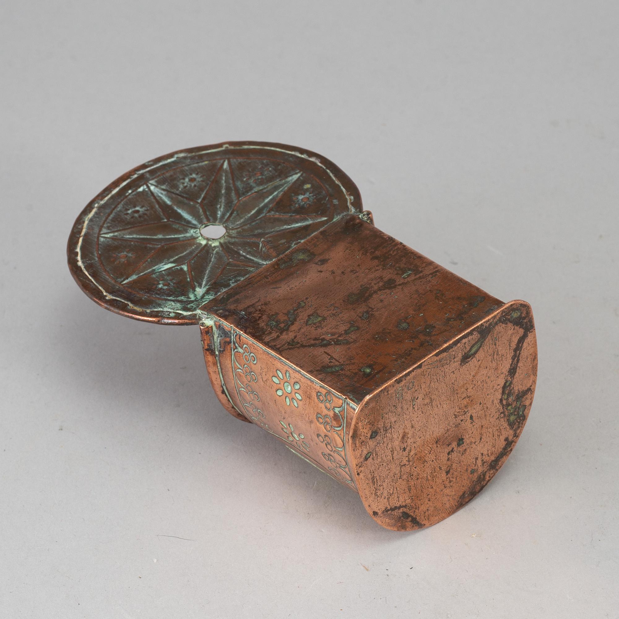 A 19th century brass and copper spoon holder.
