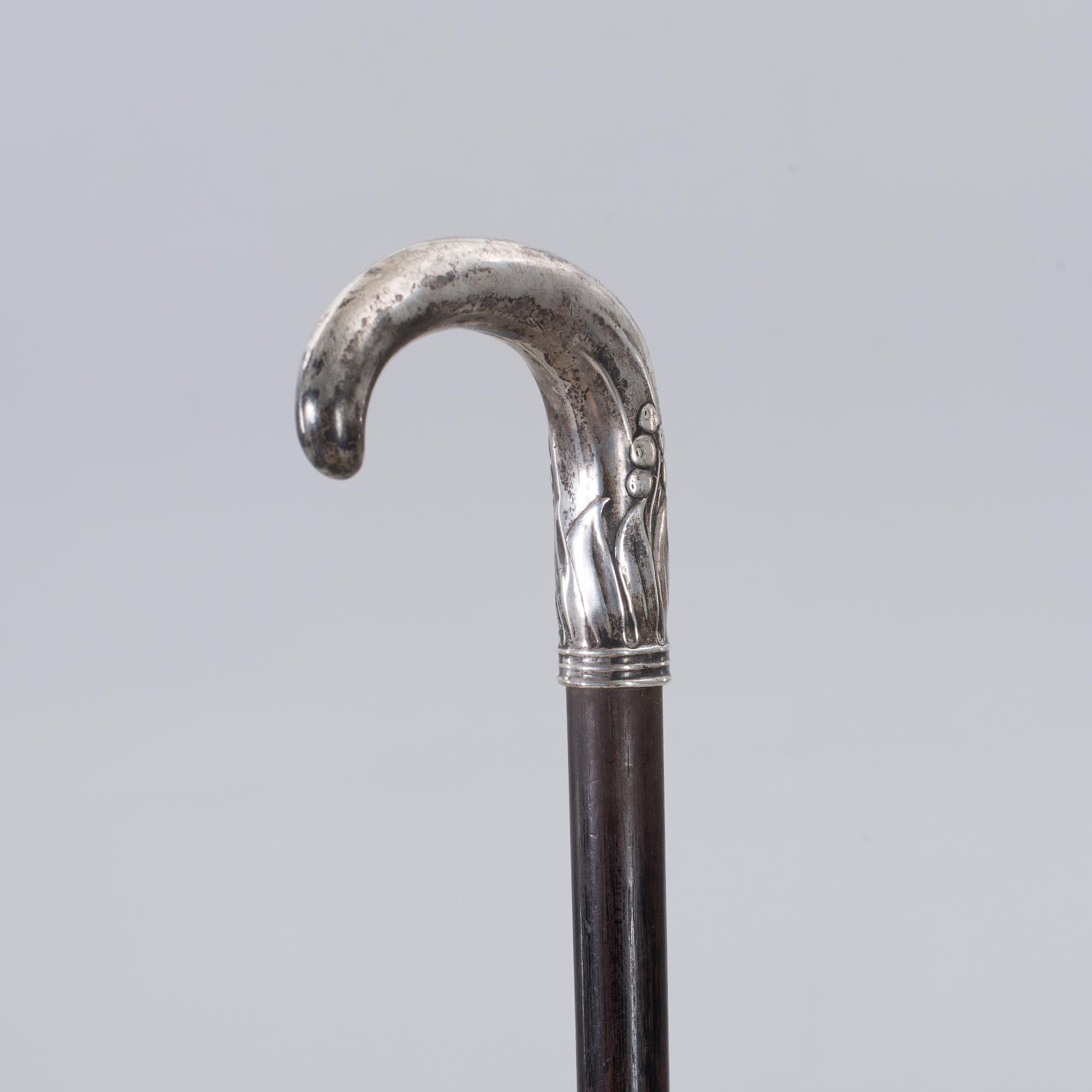 A CANE WITH SILVER MOUNTING, 1910.