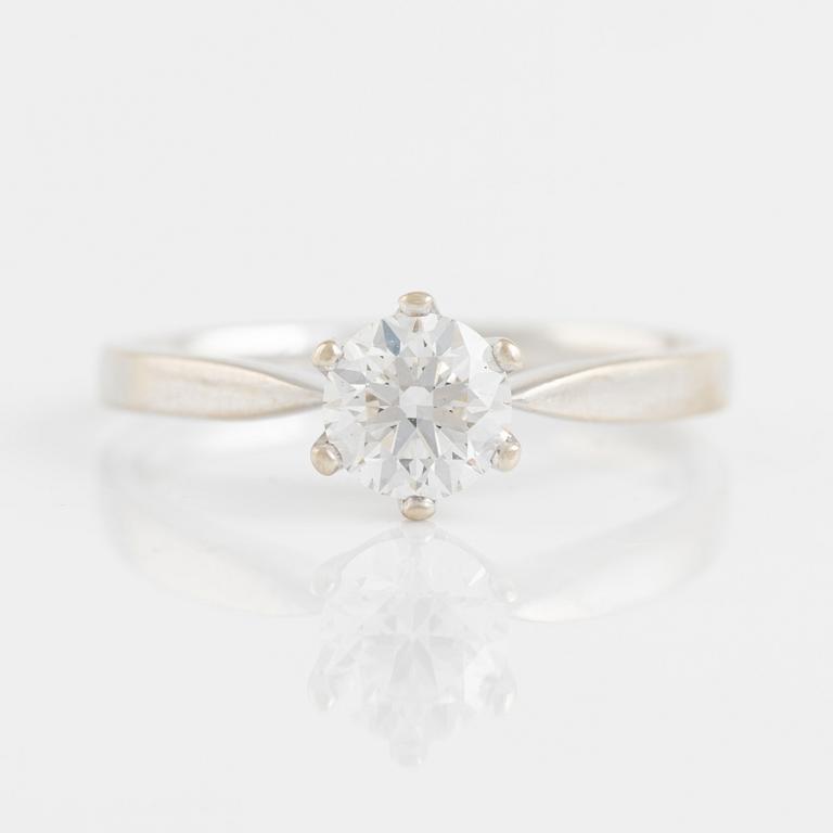 A 14K gold ring set with a round brilliant-cut diamond.