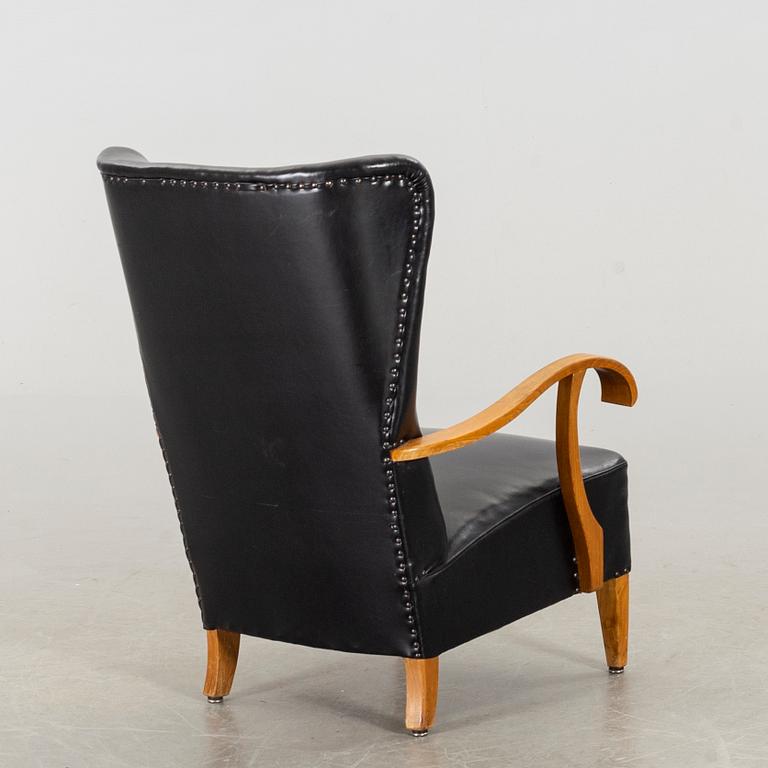 A 1940's - 50's easy chair in black leather, Scandinavian.