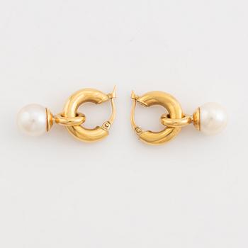 A pair of gold earrings with pearls.